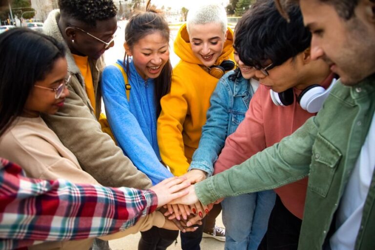 group-multiracial-college-students-stack-hands-together-circle-outdoors-community-cooperation-concepts_411082-963