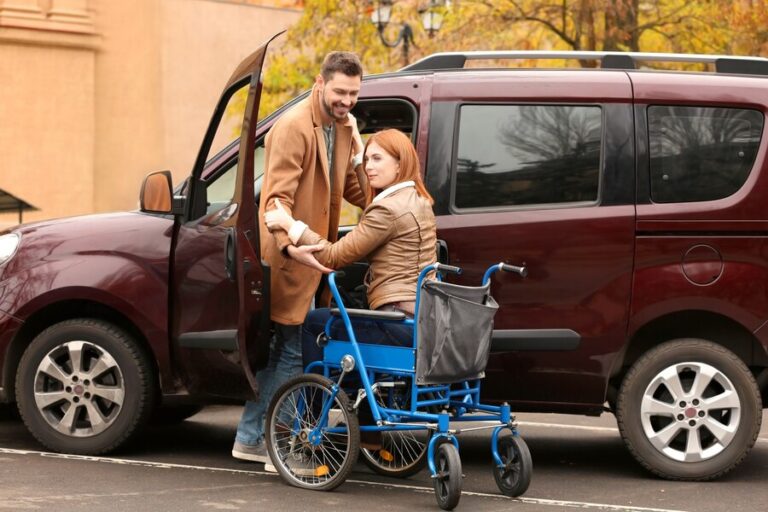 handsome-man-woman-wheelchair-near-car_392895-21020